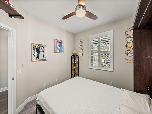 bedroom featuring ceiling fan and dark hardwood / wood-style floors