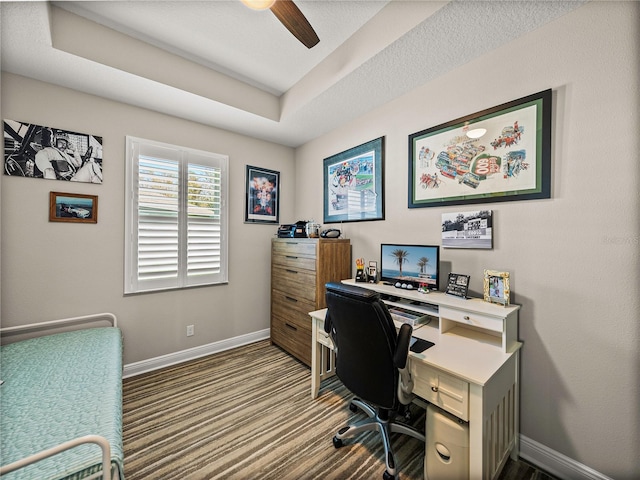 office with ceiling fan and a tray ceiling