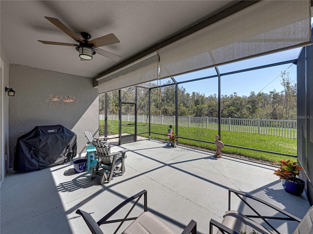 unfurnished sunroom with a wealth of natural light and ceiling fan