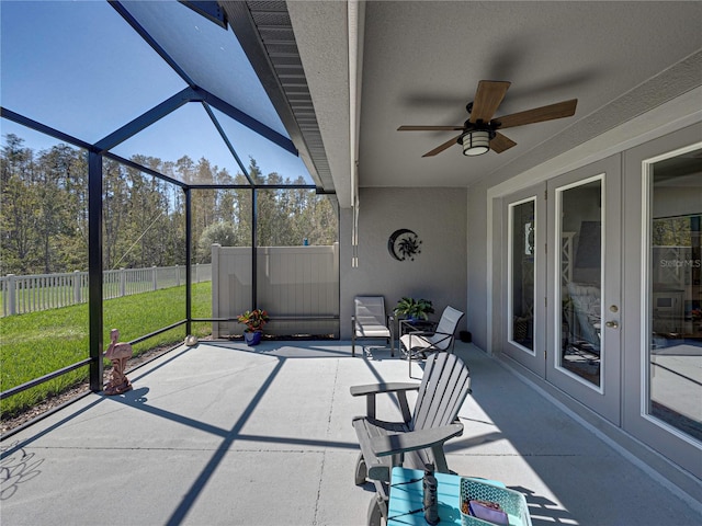 unfurnished sunroom featuring vaulted ceiling and ceiling fan