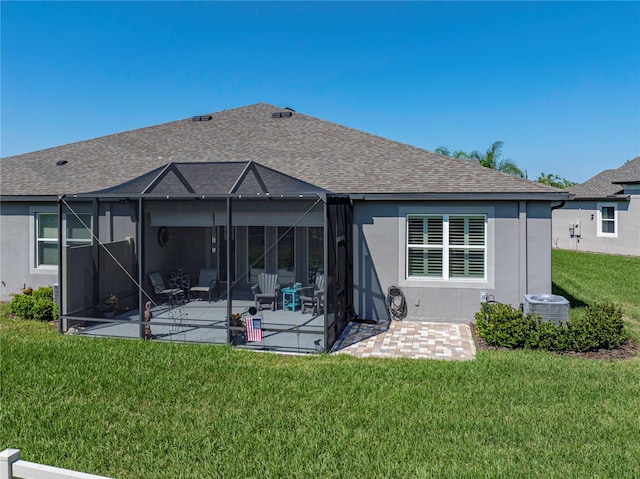 rear view of house featuring a patio area, a lanai, a lawn, and central AC unit