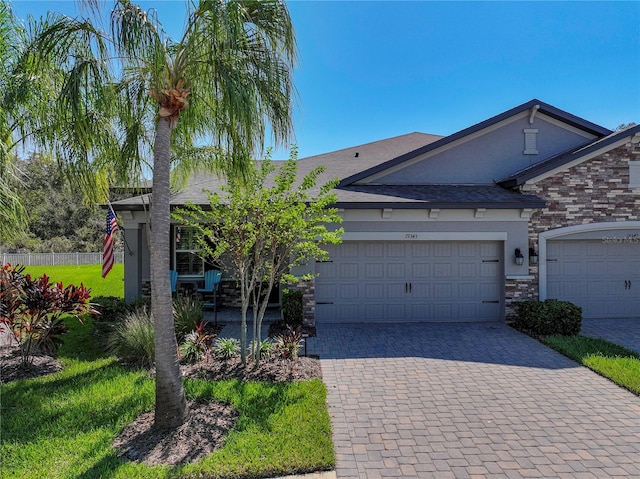 view of front of house featuring a front yard and a garage