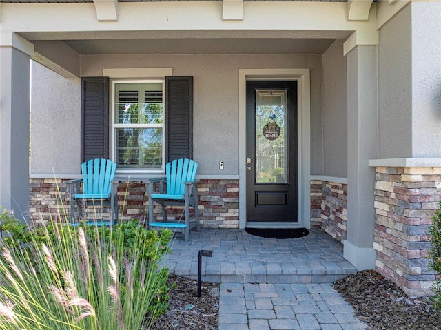 entrance to property featuring a porch