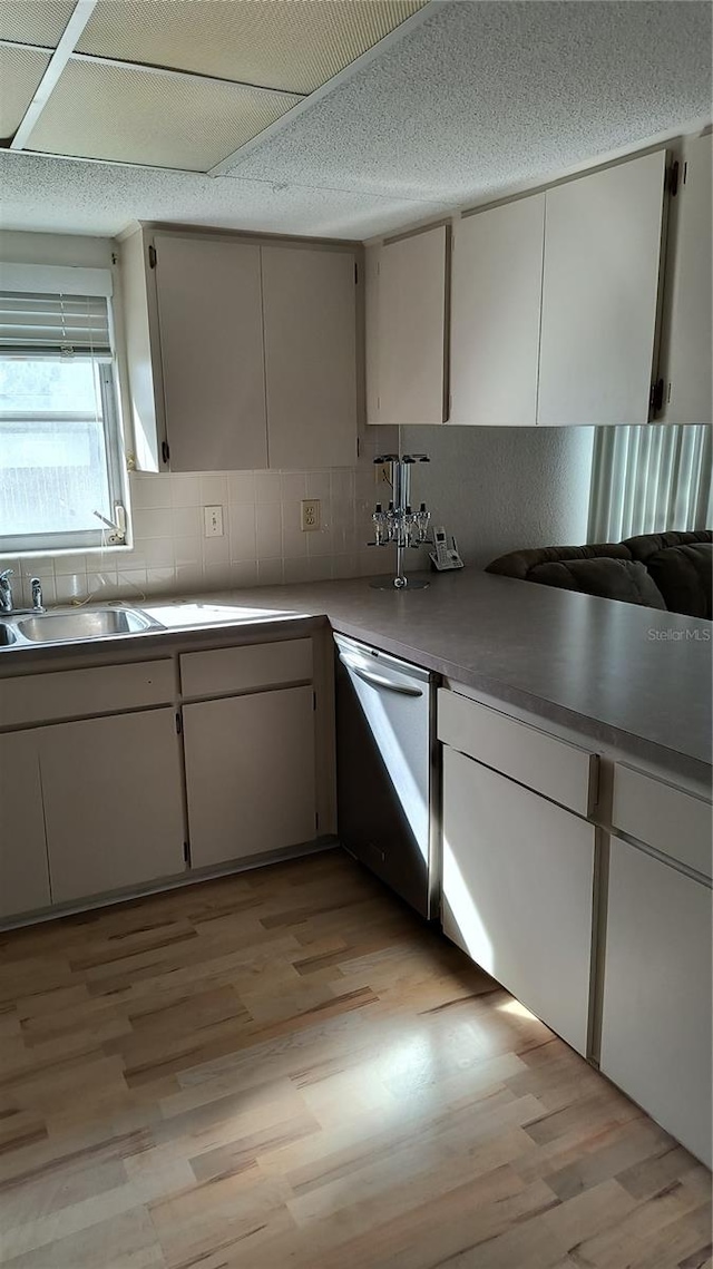 kitchen with dishwasher, white cabinets, and light hardwood / wood-style floors