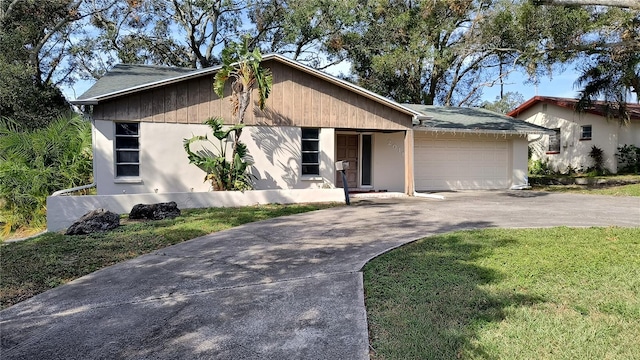 view of front of house with a garage and a front lawn