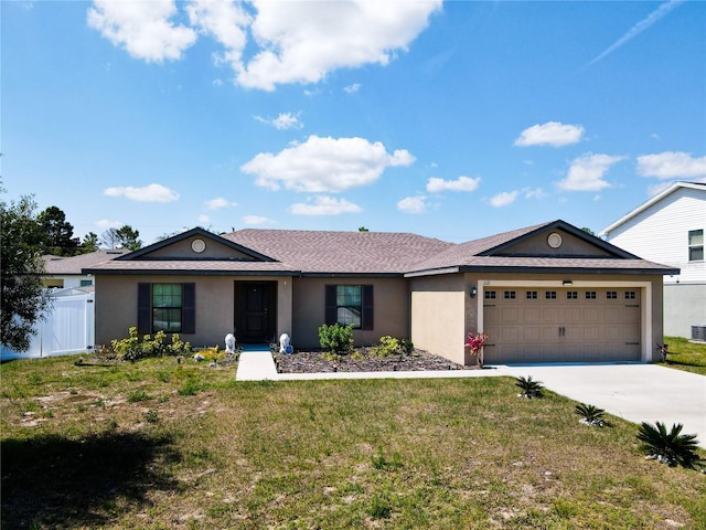 single story home featuring a garage and a front yard