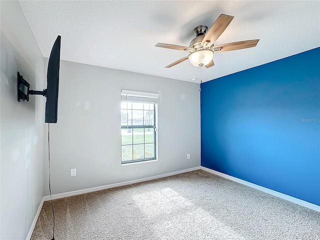 carpeted empty room with a textured ceiling and ceiling fan