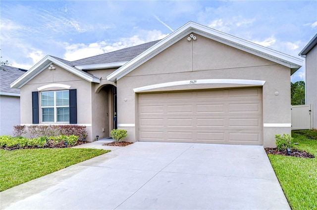 ranch-style house with a front yard and a garage