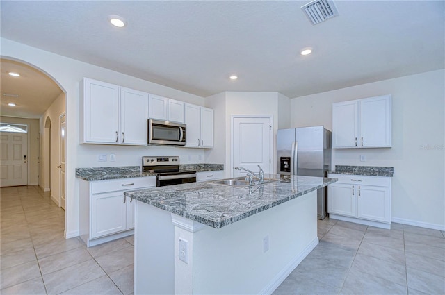 kitchen with sink, white cabinets, and appliances with stainless steel finishes