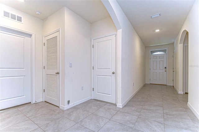 hallway featuring light tile patterned floors