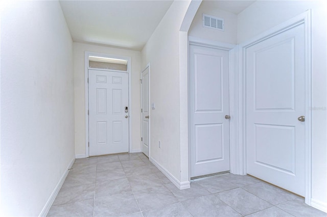 hall with light tile patterned flooring