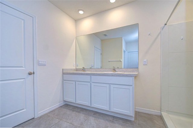 bathroom featuring tile patterned floors, vanity, and a shower