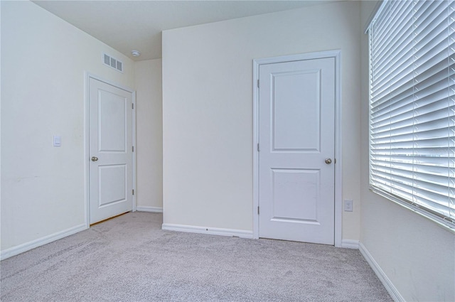 unfurnished room with light carpet