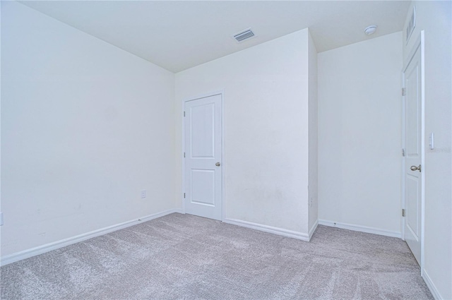 empty room featuring light colored carpet