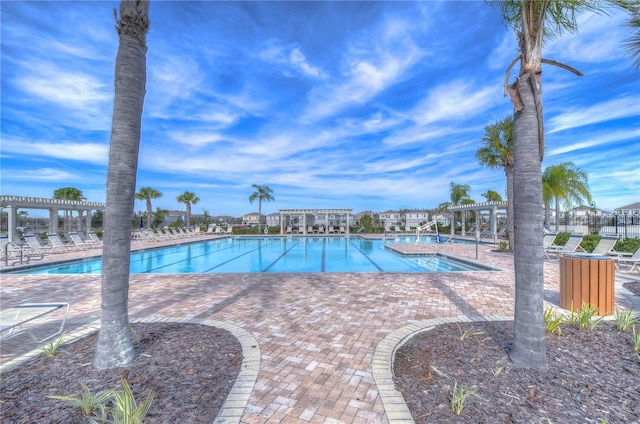 view of pool with a pergola and a patio