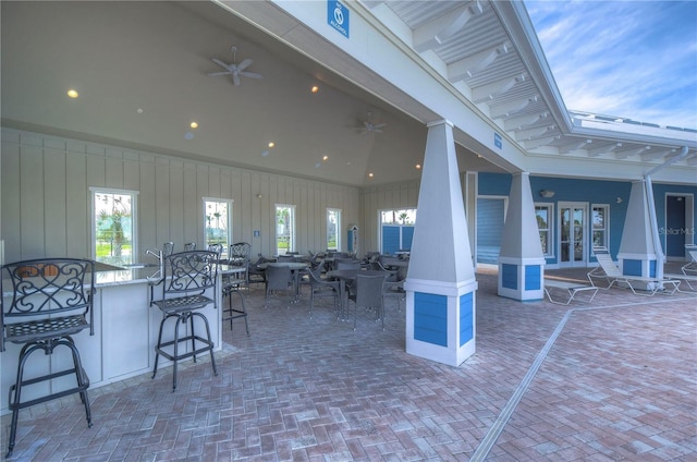 view of patio featuring ceiling fan and exterior bar