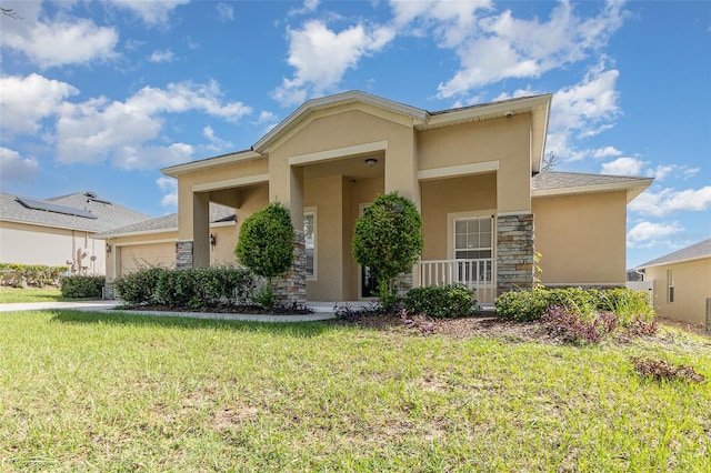 view of front of property featuring a front yard and a garage