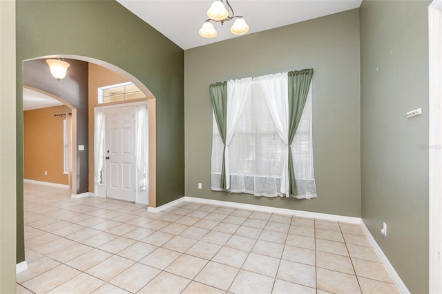 tiled foyer with an inviting chandelier