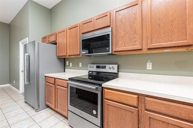 kitchen featuring appliances with stainless steel finishes and light tile patterned flooring