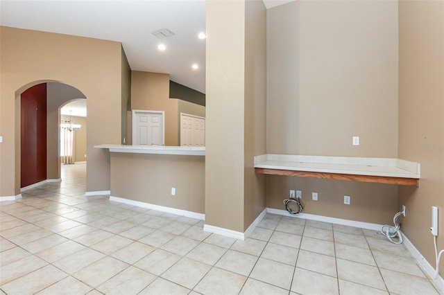 interior space featuring an inviting chandelier and light tile patterned flooring