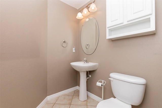 bathroom with sink, tile patterned flooring, and toilet