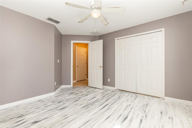 unfurnished bedroom featuring light hardwood / wood-style flooring, ceiling fan, and a closet