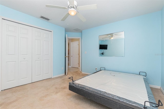 carpeted bedroom with a closet and ceiling fan