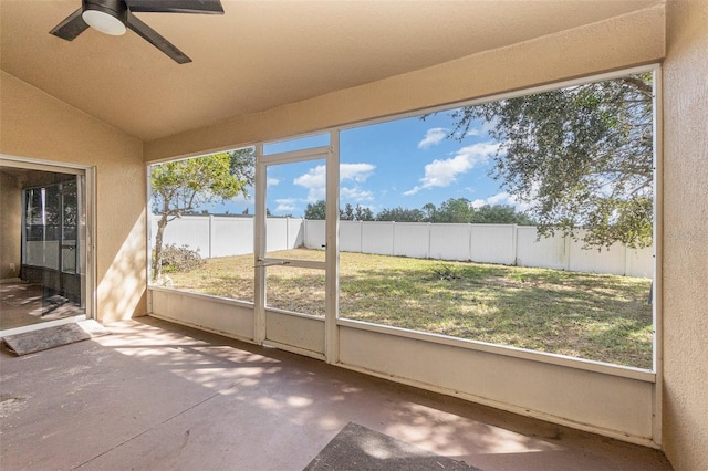 unfurnished sunroom with lofted ceiling and ceiling fan