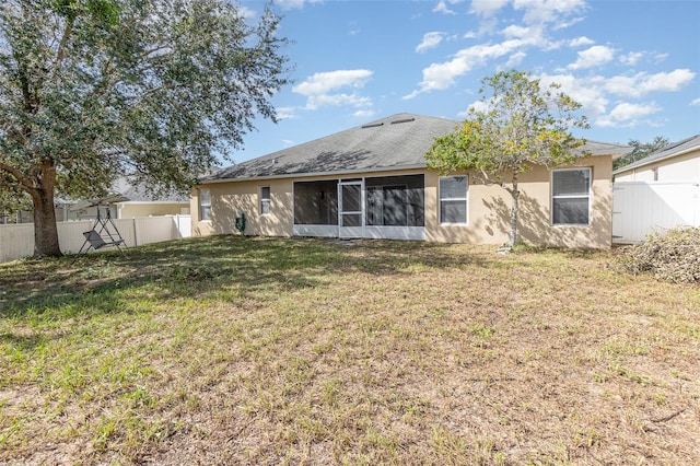 back of property featuring a lawn