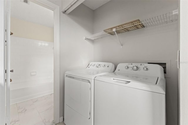 clothes washing area with washing machine and clothes dryer