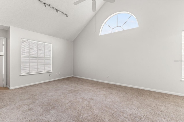 spare room with ceiling fan, lofted ceiling, and carpet flooring