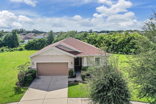 view of front of home featuring a front yard and a garage