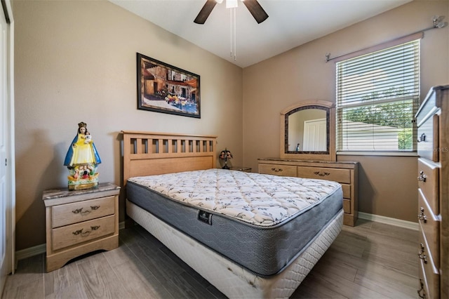 bedroom with dark hardwood / wood-style floors and ceiling fan