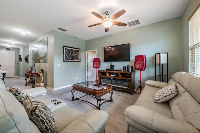 living room with ceiling fan and light hardwood / wood-style flooring