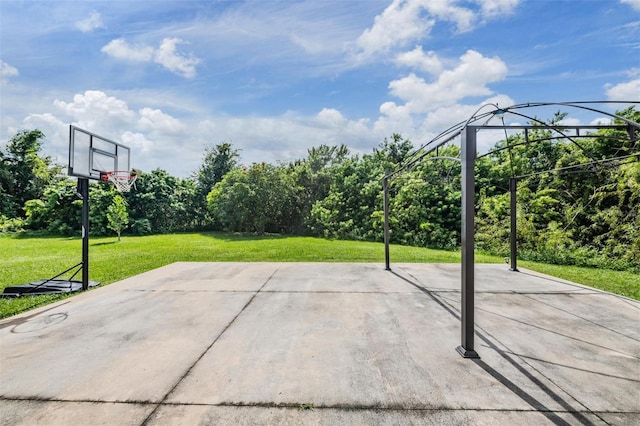 view of basketball court with a lawn