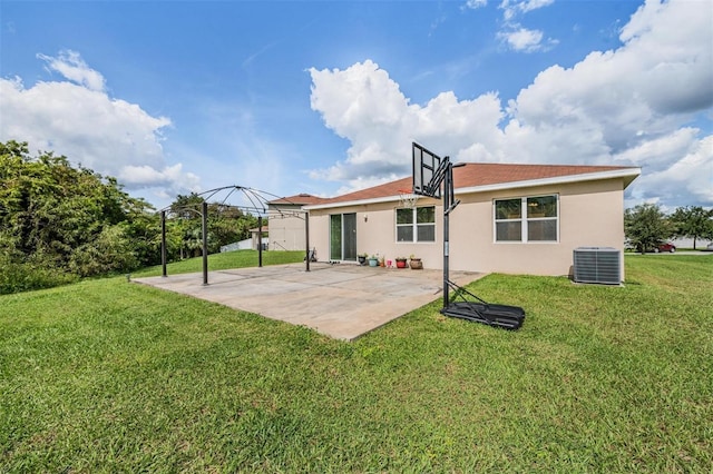 rear view of house featuring cooling unit, a patio area, and a lawn