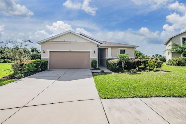 view of front of home featuring a front yard and a garage