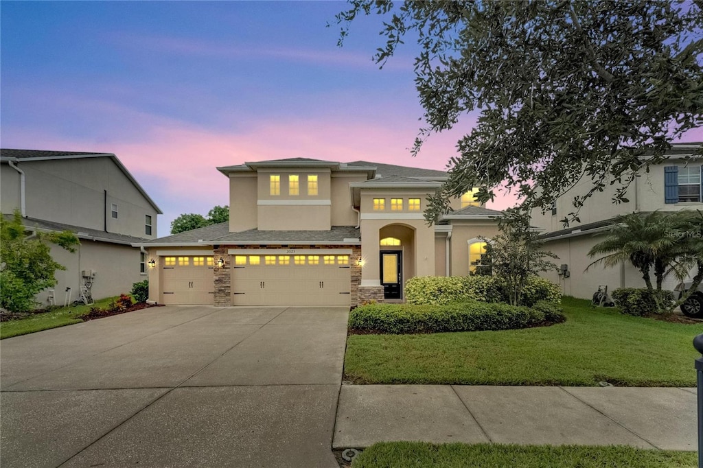 view of front facade featuring a lawn and a garage