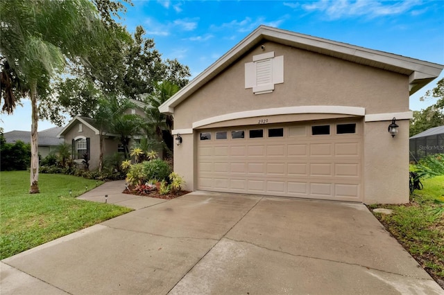 view of front of house featuring a garage and a front lawn