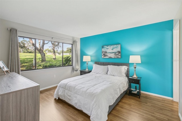 bedroom with dark hardwood / wood-style flooring