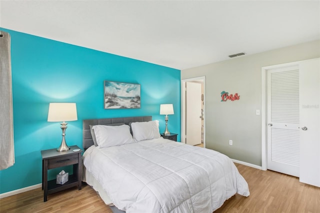 bedroom featuring light hardwood / wood-style flooring and a closet