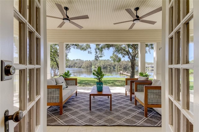 sunroom / solarium with a water view