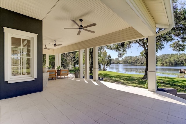 view of patio / terrace featuring ceiling fan and a water view