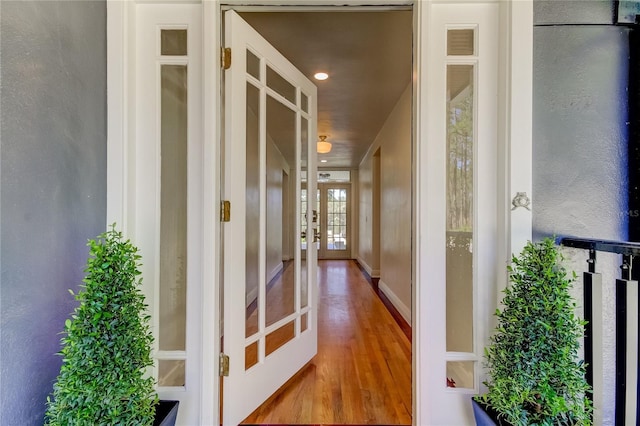 hallway featuring french doors and wood-type flooring