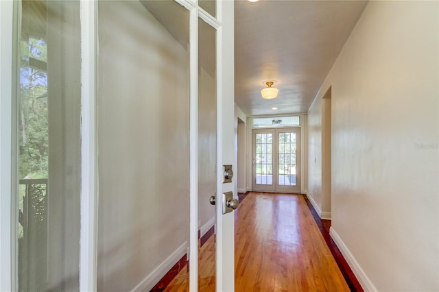 doorway with french doors and hardwood / wood-style flooring