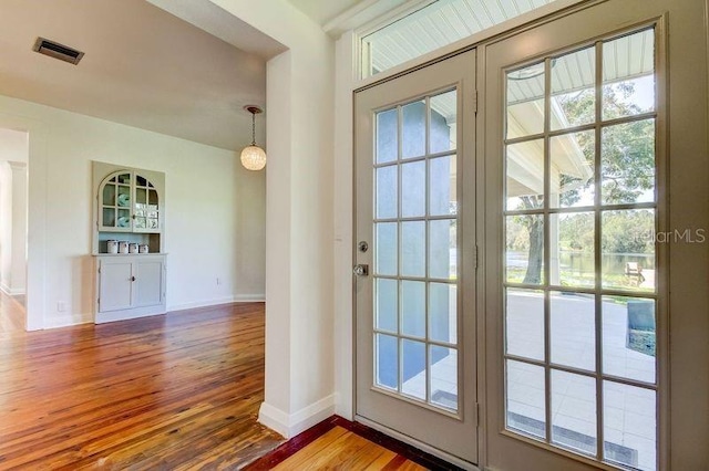 entryway with french doors, hardwood / wood-style floors, and plenty of natural light