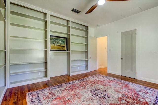 unfurnished living room featuring ceiling fan, built in features, and wood-type flooring