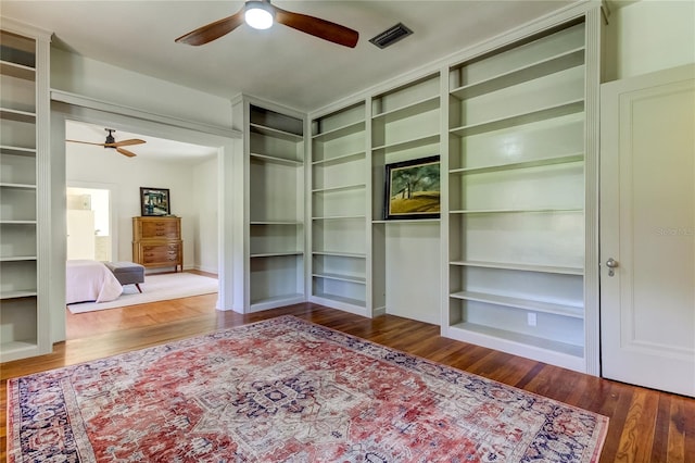 interior space with ceiling fan and dark wood-type flooring