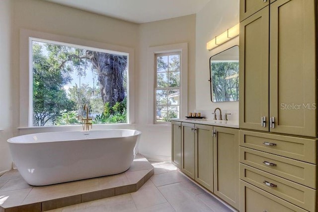 bathroom with tile patterned floors, vanity, and a bathing tub