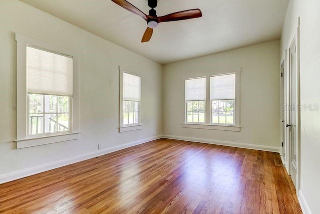 empty room featuring ceiling fan and hardwood / wood-style floors